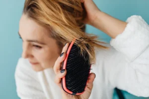 Close-up of a woman gently brushing her hair