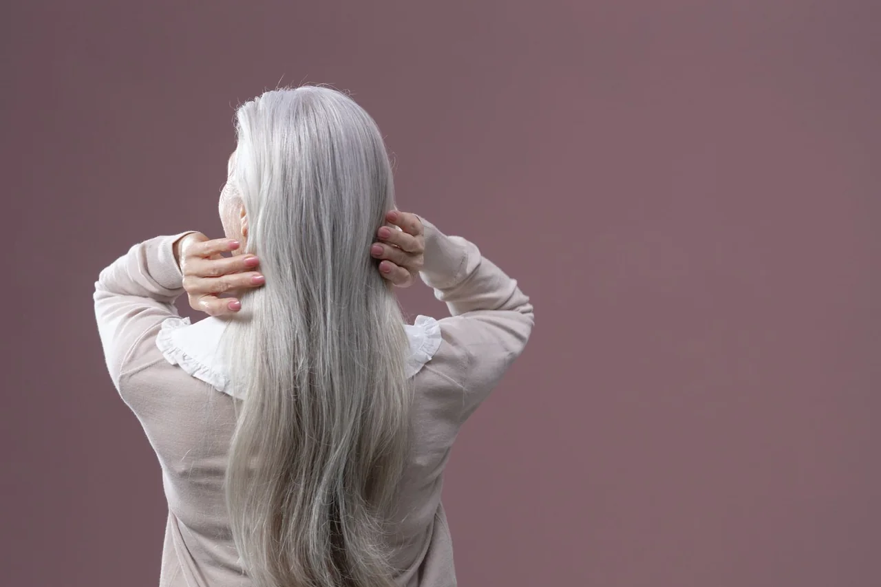 Back view of a woman with long natural silver hair